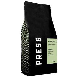 Black coffee bag with 'PRESS' branding and text on a white background