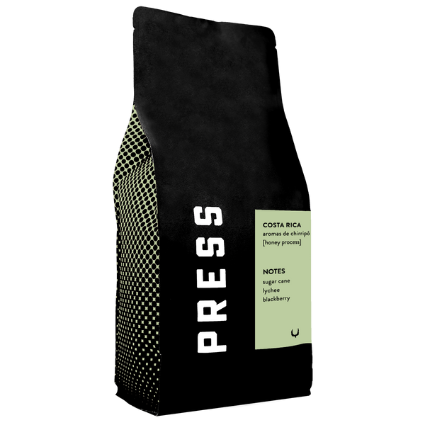 Black coffee bag with 'PRESS' branding and text on a white background