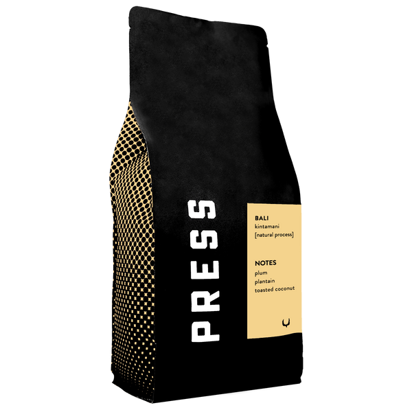 Black coffee bag with gold accents and 'PRESS' branding on a white background