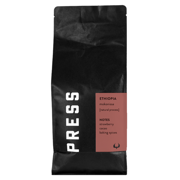 Black coffee bag with 'PRESS' branding and Ethiopia Mokonissa coffee details on a white background