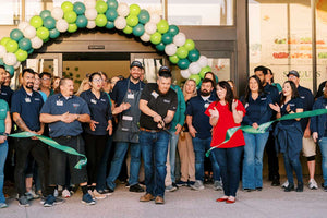 Sprouts Higley ribbon cuttin ceremony. Numerous Sprouts employees stand in front of their new store with a balloon arch. 
